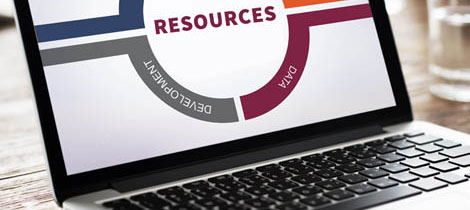 A laptop with the word "RESOURCES" written across the screen