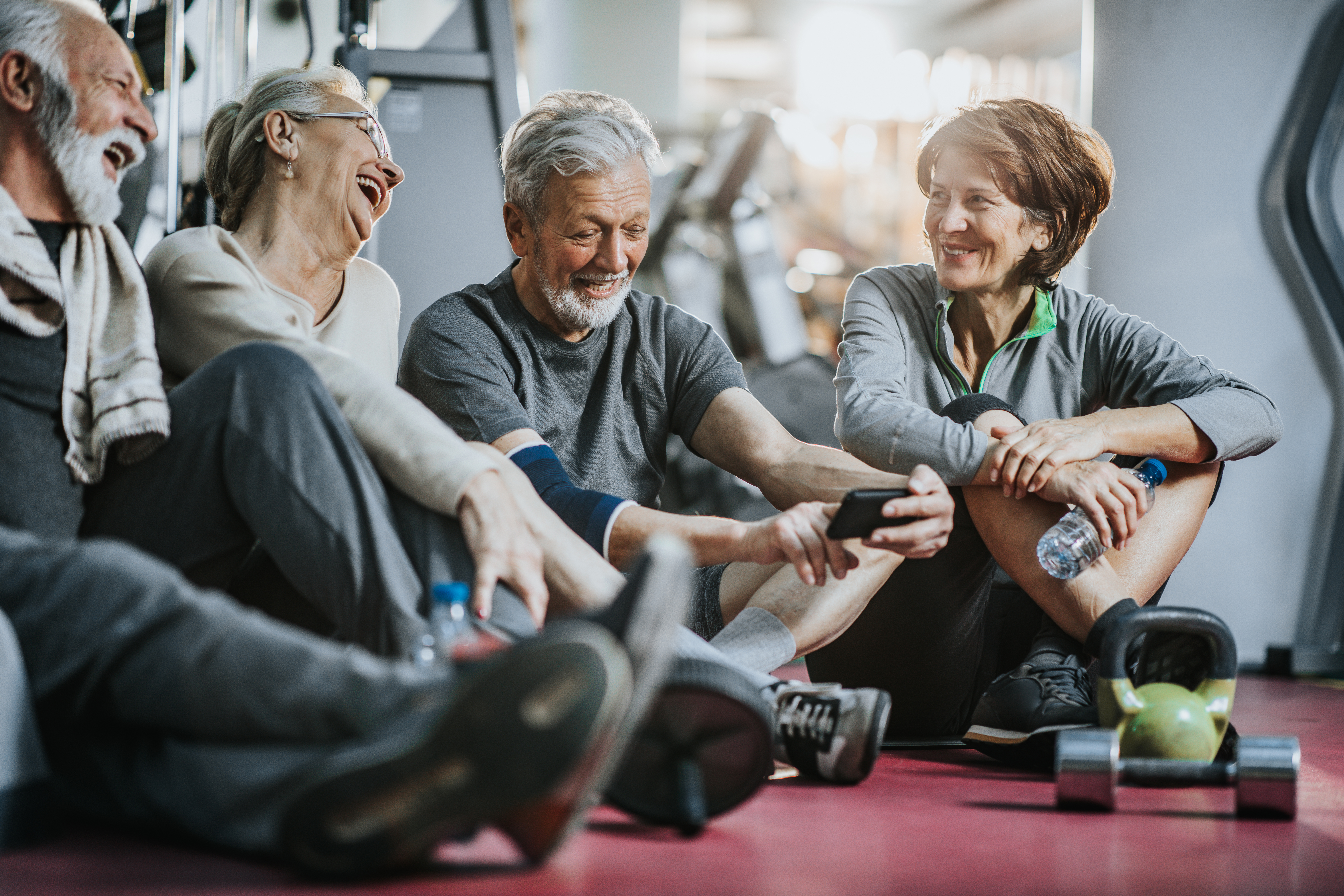 A group of senior friends at the gym laughing