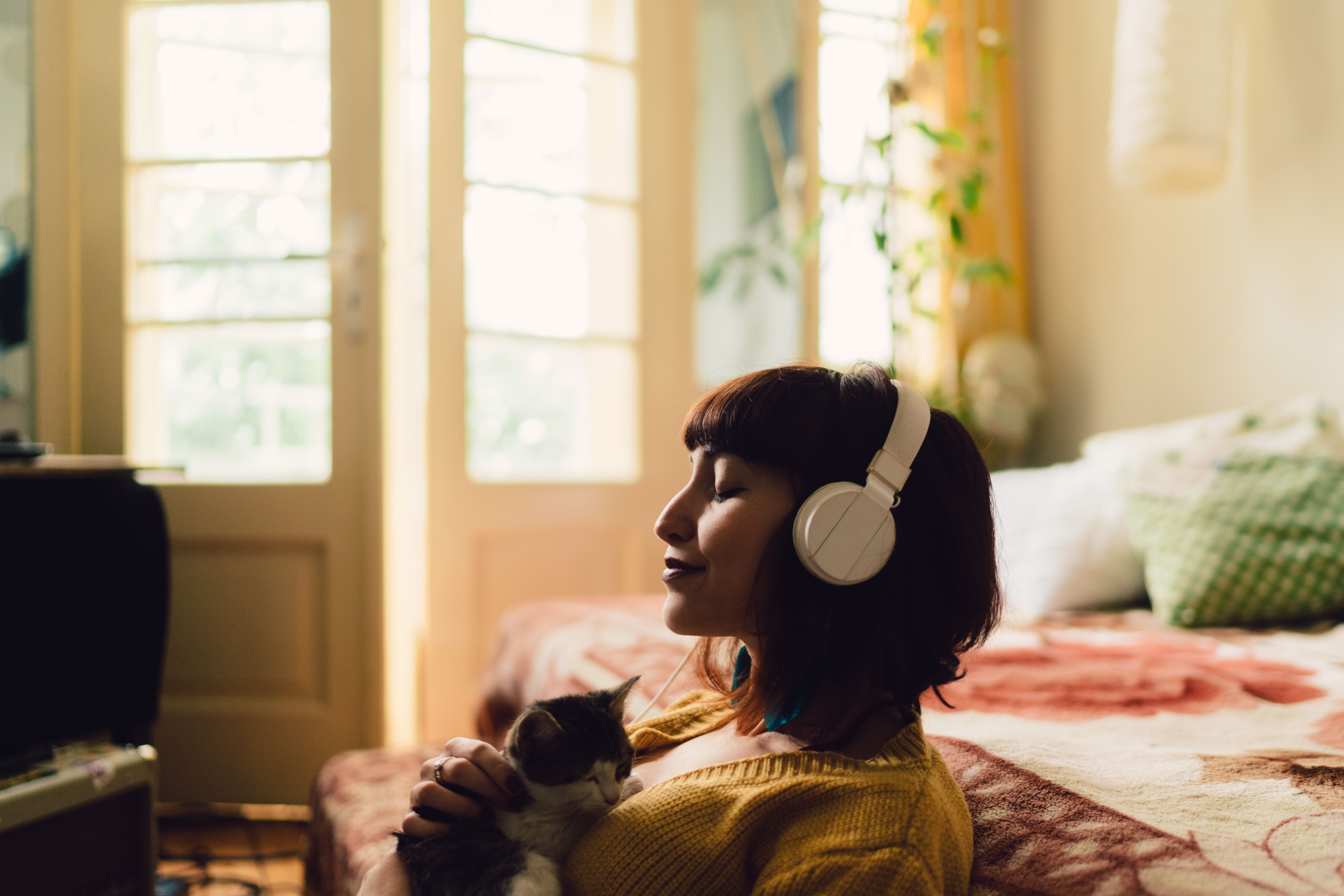 A woman listening to calming music with her pet