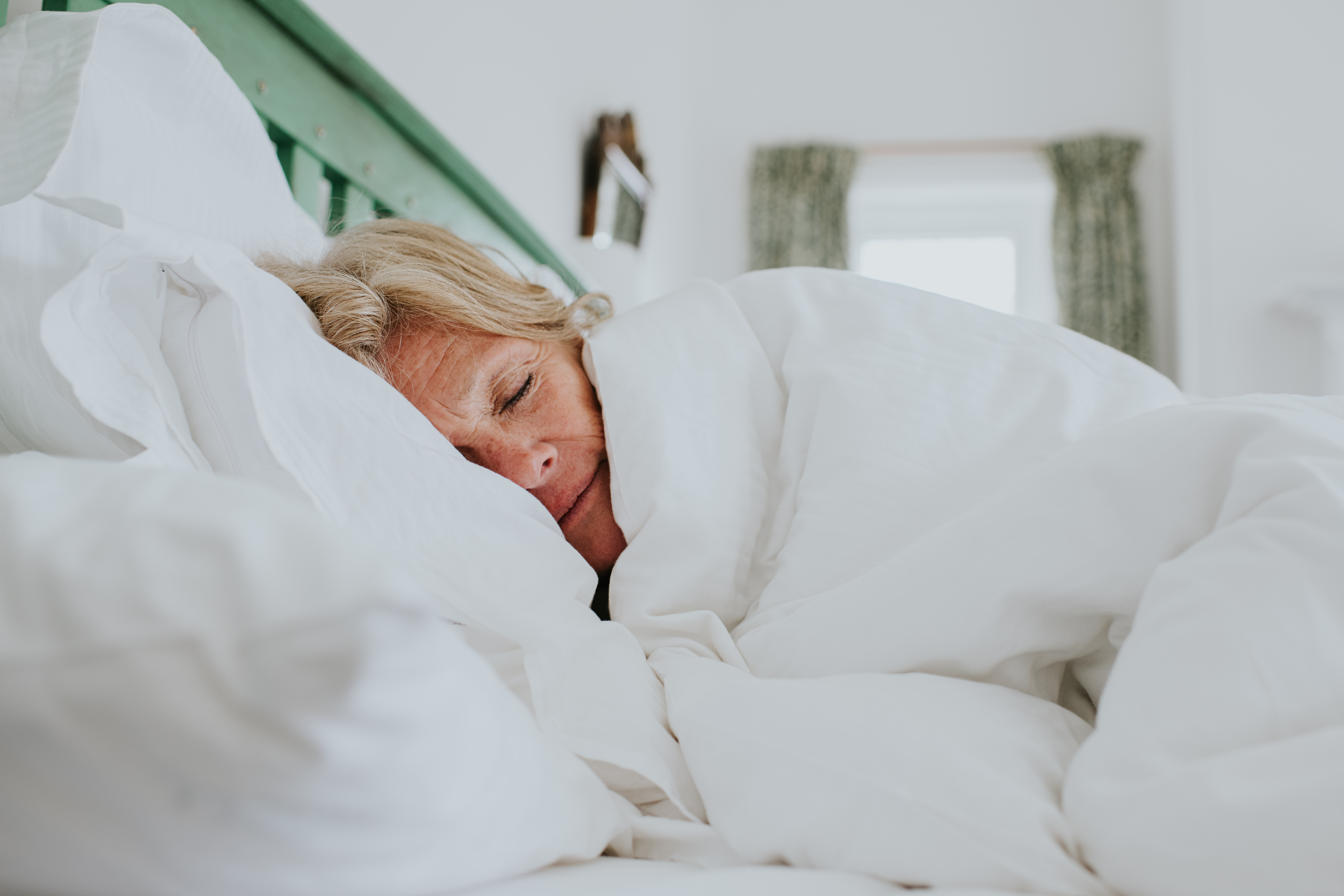A woman sleeping comfortably in bed